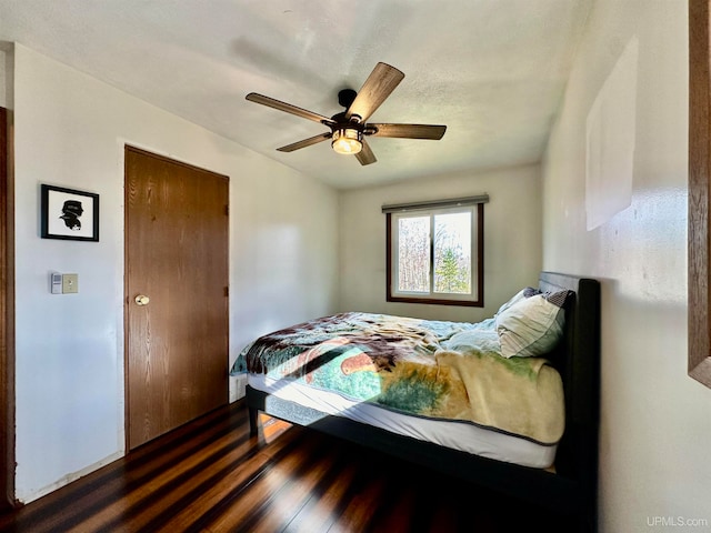 bedroom with ceiling fan, a closet, and dark hardwood / wood-style floors