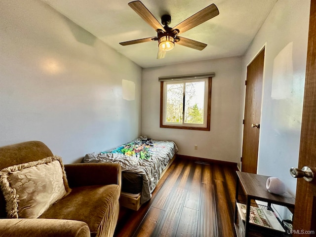 bedroom with ceiling fan and dark hardwood / wood-style floors