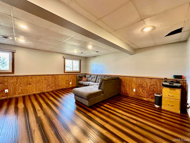 unfurnished room with wooden walls, dark hardwood / wood-style flooring, and plenty of natural light