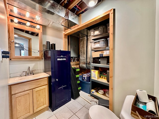 bathroom with tile patterned flooring and vanity