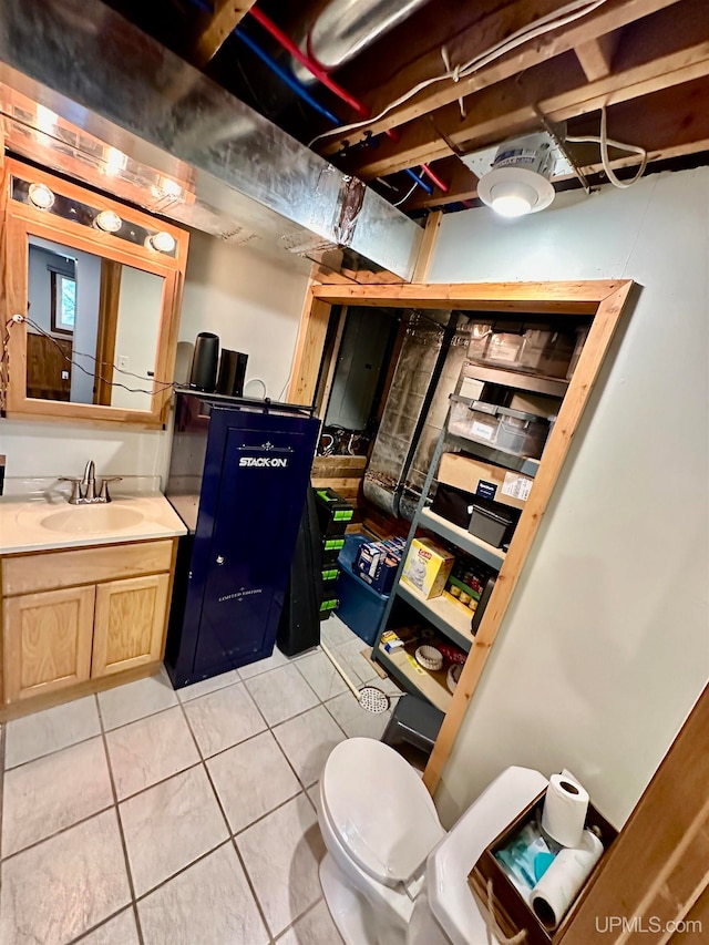 bathroom featuring tile patterned floors, vanity, and toilet