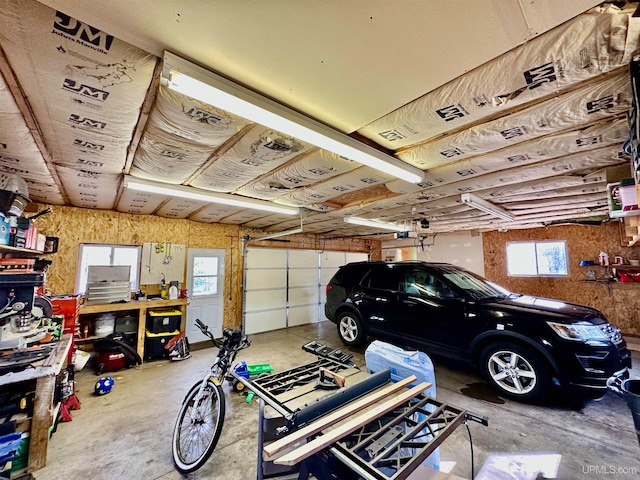 garage with a workshop area and a garage door opener