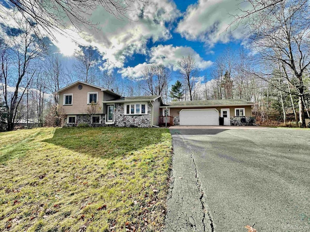 tri-level home with a front yard and a garage