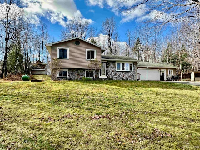 tri-level home with a front yard and a garage