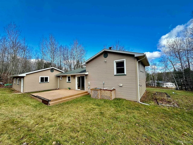 rear view of house with a yard and a deck