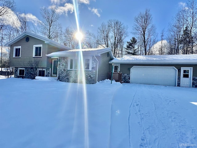 view of snow covered exterior featuring a garage