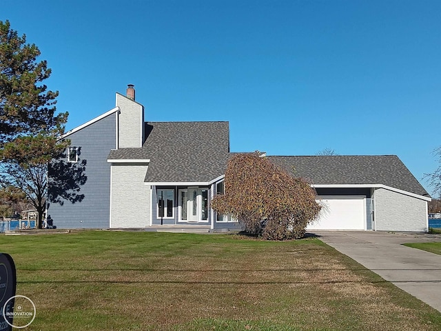 view of front of property with a front lawn and a garage