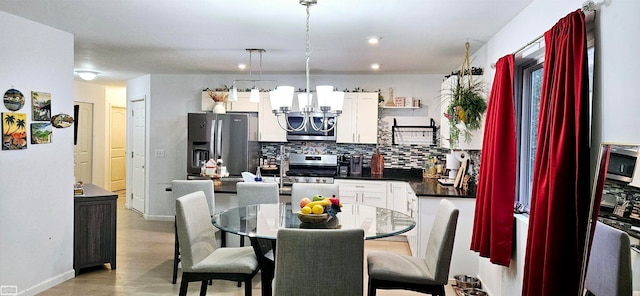 dining space featuring a notable chandelier and light hardwood / wood-style flooring