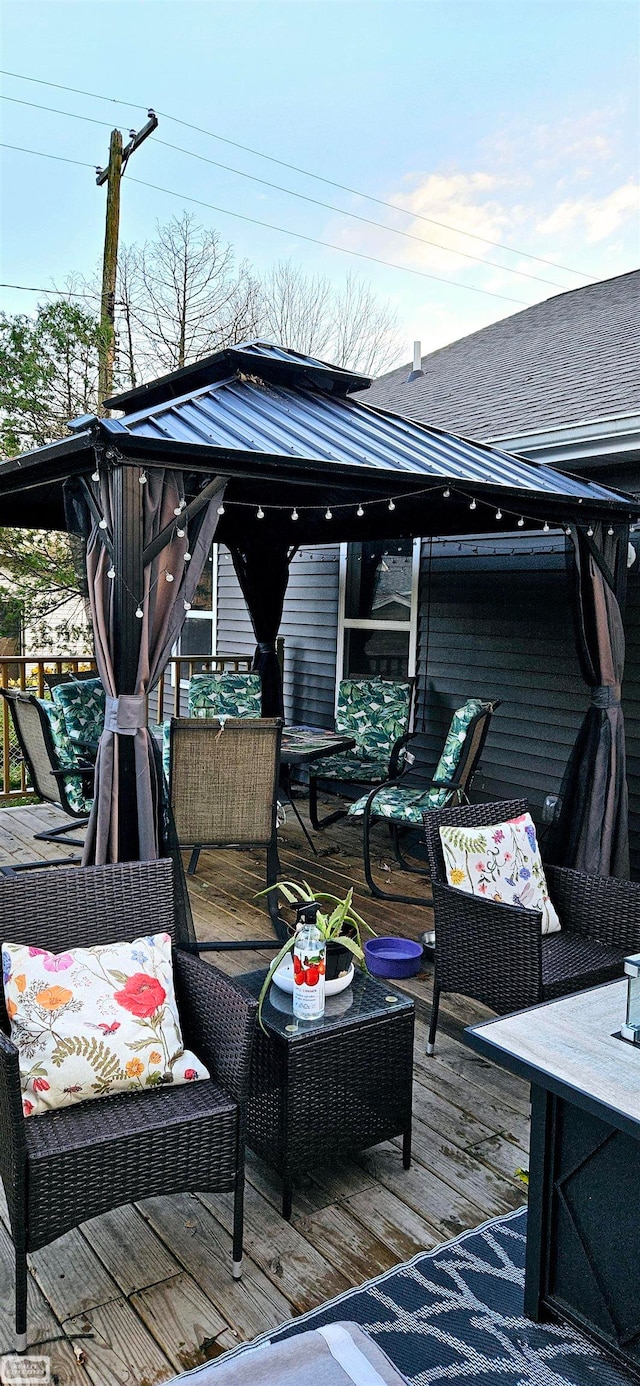 deck with a gazebo and an outdoor hangout area