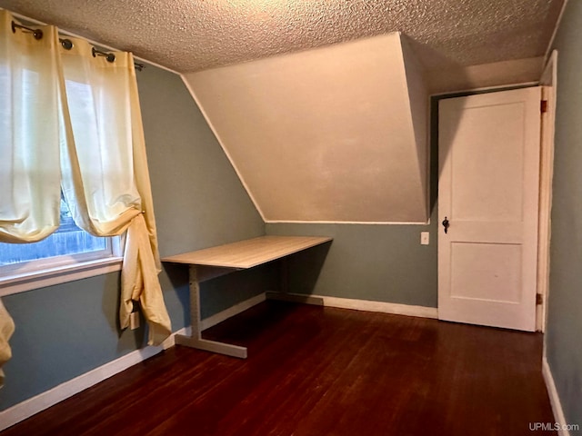 interior space with dark hardwood / wood-style flooring and a textured ceiling