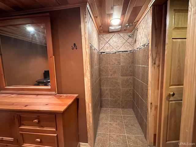 bathroom featuring tiled shower, vanity, and wooden ceiling