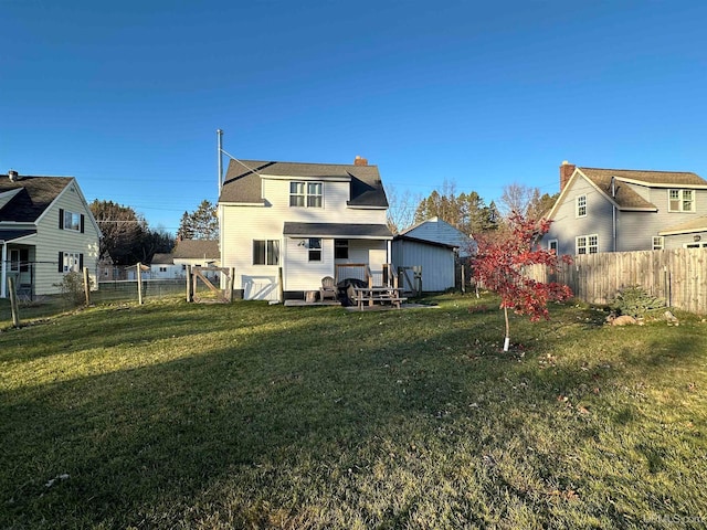 back of property featuring a yard