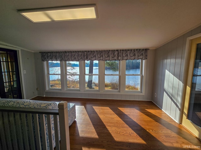 interior space with crown molding and wood finished floors