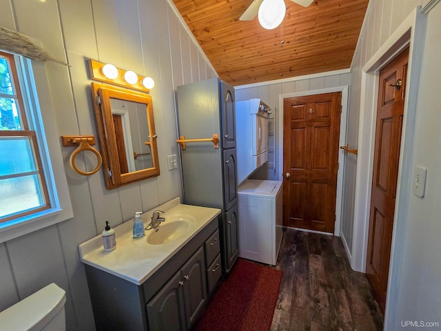 half bathroom featuring stacked washer and dryer, toilet, wooden ceiling, wood finished floors, and vaulted ceiling