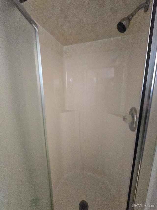 bathroom with a shower stall