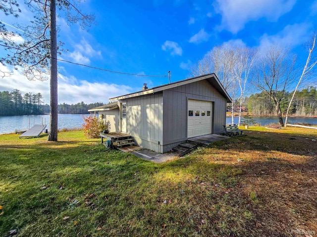 detached garage featuring a water view