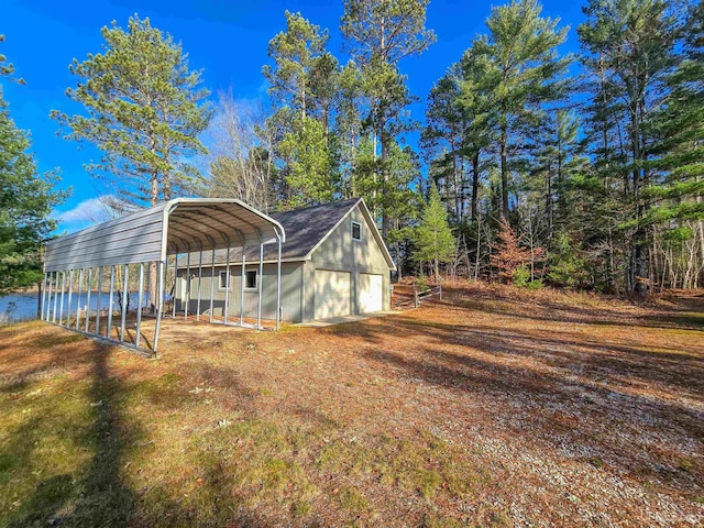 exterior space with a garage, driveway, and a detached carport