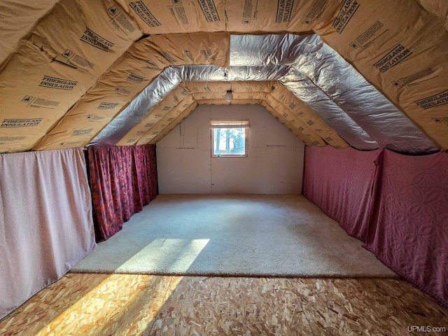 bonus room with carpet floors and vaulted ceiling