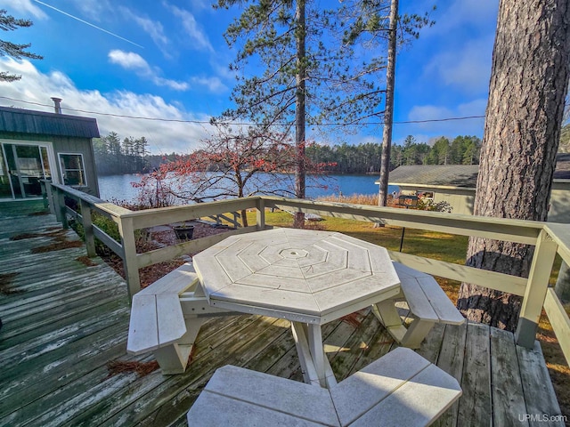 wooden deck featuring a water view