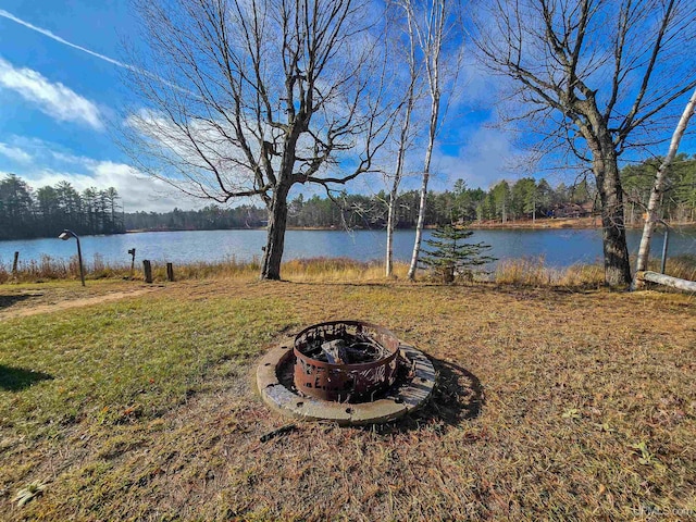 view of yard with a water view and a fire pit