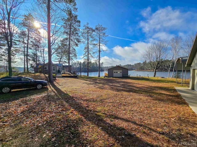 view of yard with an outbuilding and a water view