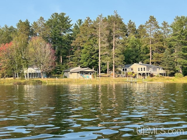 property view of water featuring a forest view