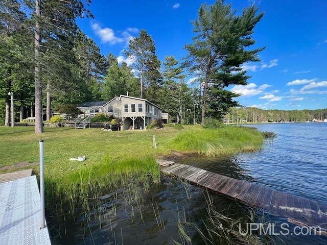 view of dock featuring a yard and a water view