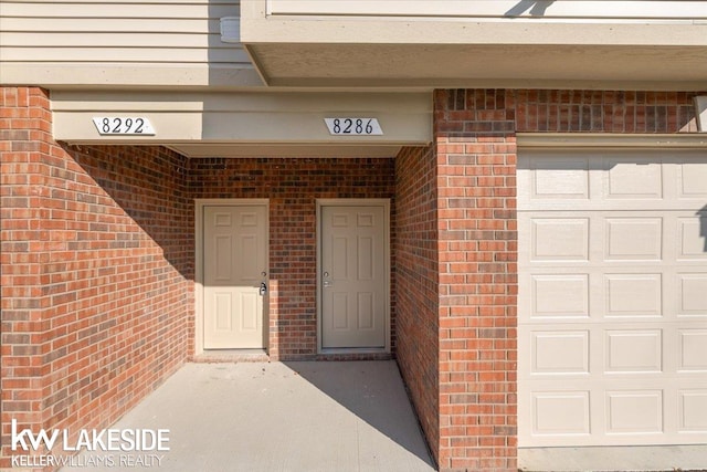 view of exterior entry with a garage