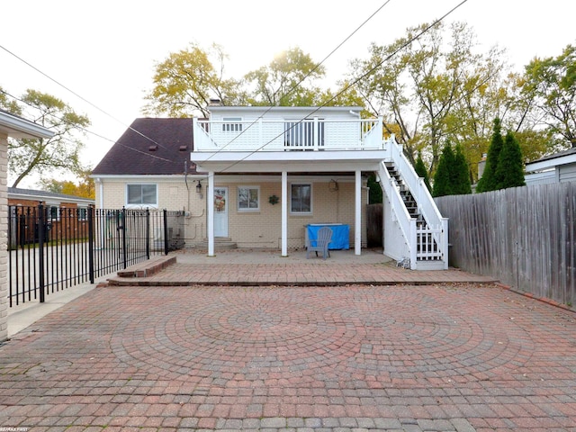 rear view of house with a patio and a wooden deck