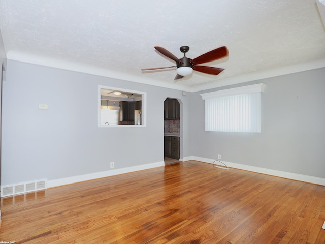 unfurnished room featuring hardwood / wood-style floors, ceiling fan, and a textured ceiling