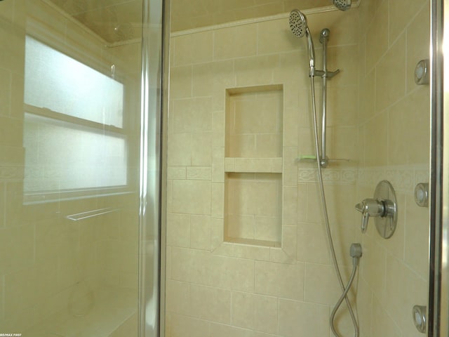 bathroom featuring a shower with door