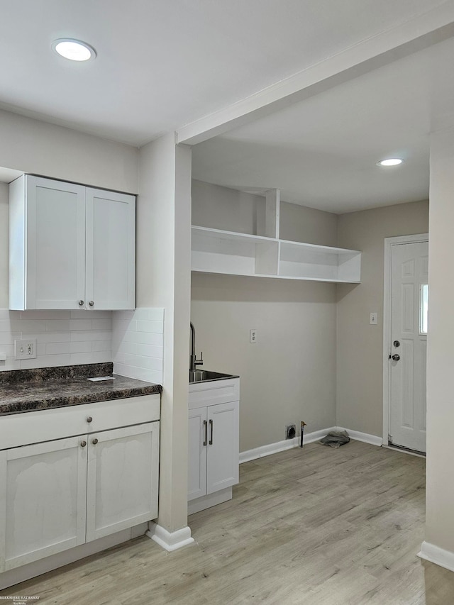 laundry room with light wood-type flooring and sink