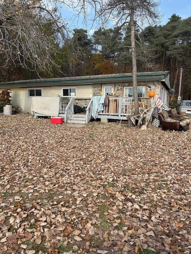 rear view of property featuring a deck