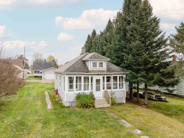 back of house featuring a sunroom and a yard