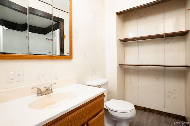 bathroom featuring hardwood / wood-style flooring, vanity, and toilet