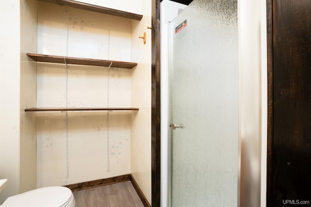 bathroom featuring hardwood / wood-style floors and toilet