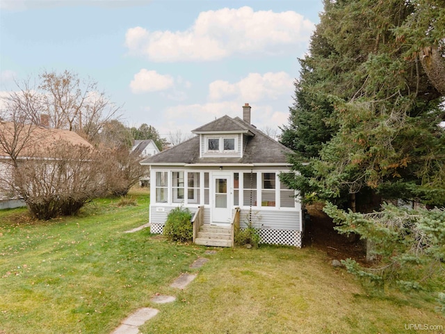 rear view of property with a yard