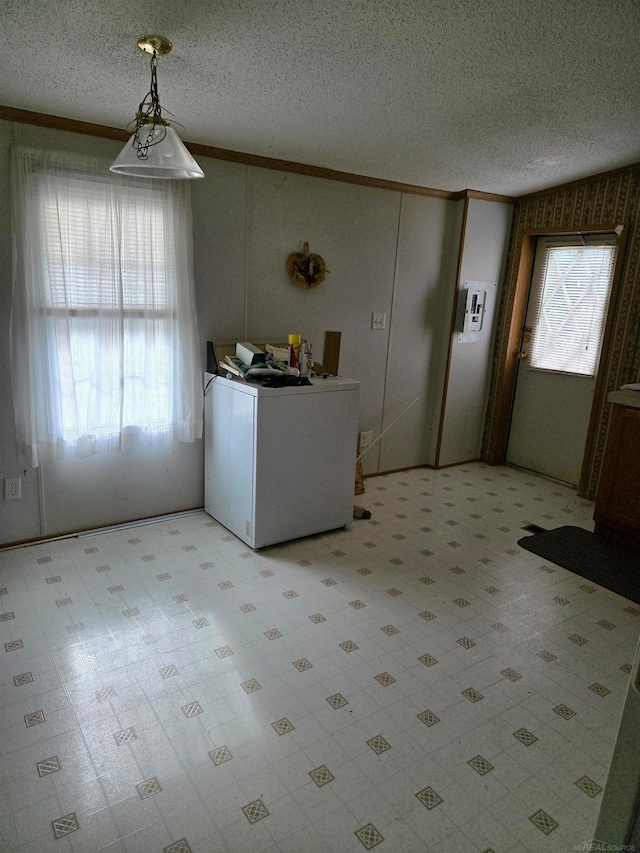 kitchen with crown molding, hanging light fixtures, and a textured ceiling