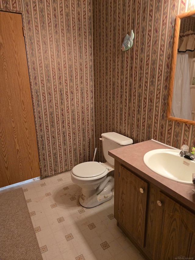 bathroom featuring vanity and toilet