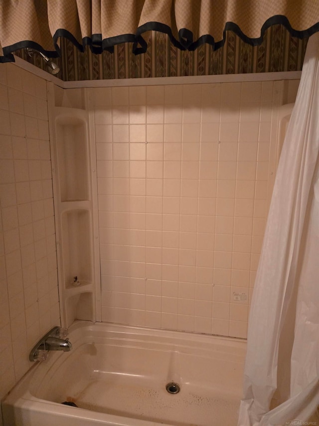 bathroom with shower / bathtub combination with curtain