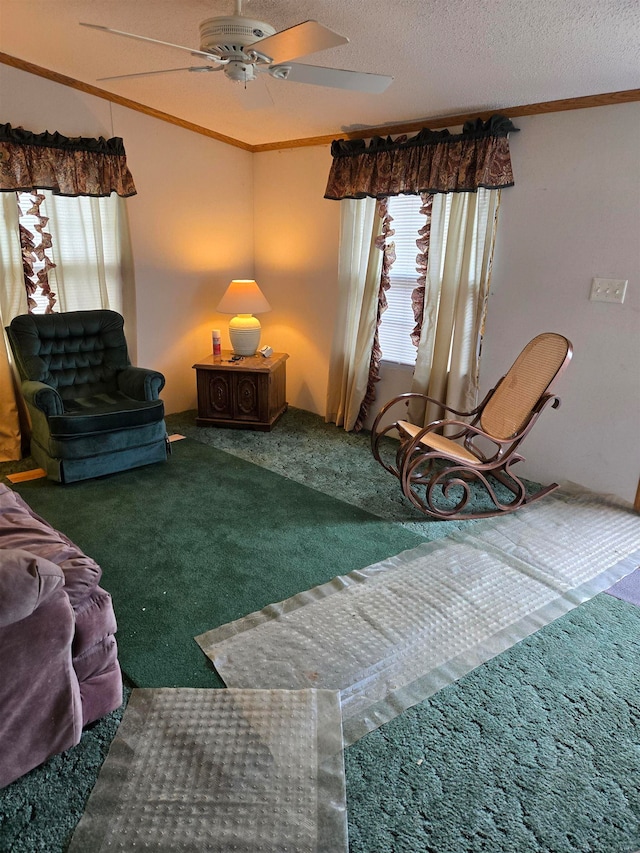 living room with ceiling fan, carpet floors, a textured ceiling, and ornamental molding