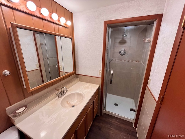 bathroom featuring an enclosed shower, vanity, and hardwood / wood-style flooring