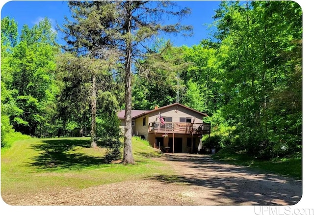 view of front of home featuring a front yard and a deck