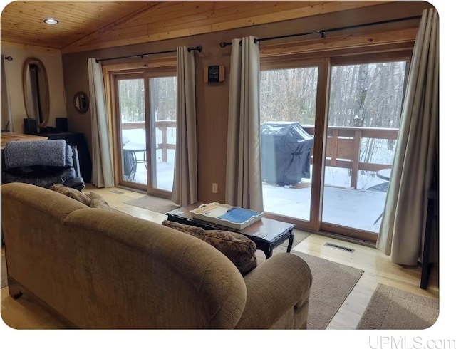 living room with a wealth of natural light, vaulted ceiling, light hardwood / wood-style floors, and wood ceiling