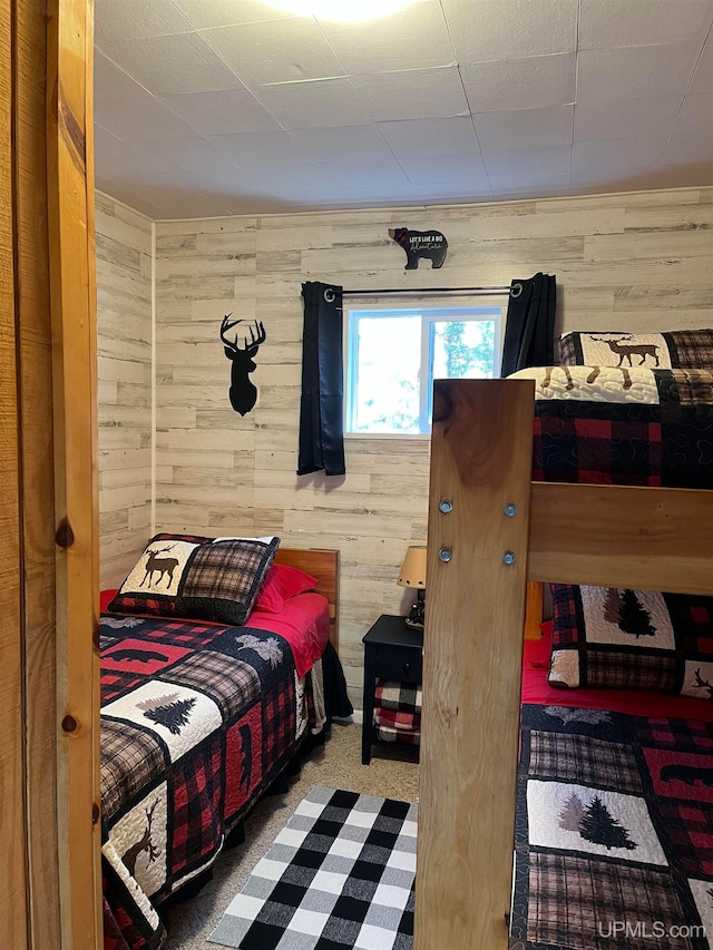 bedroom with wooden walls