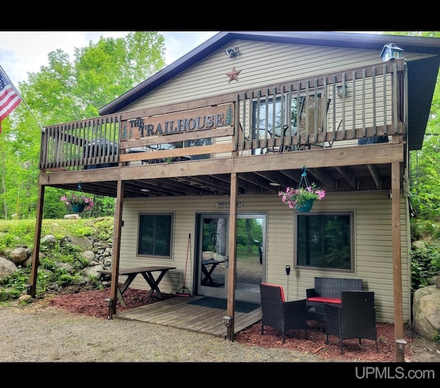 back of house featuring a wooden deck