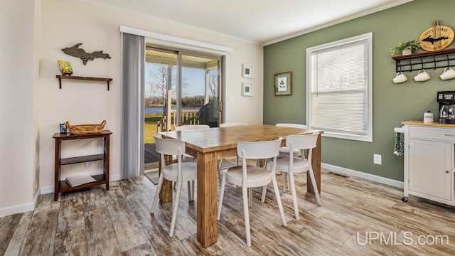 dining area featuring hardwood / wood-style floors and ornamental molding