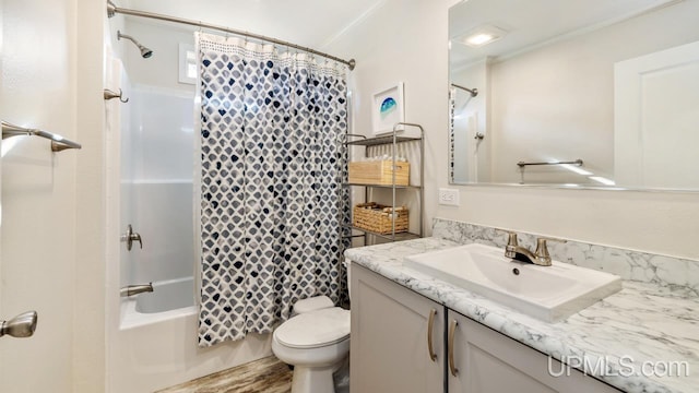 full bathroom featuring ornamental molding, vanity, shower / bath combo, hardwood / wood-style flooring, and toilet