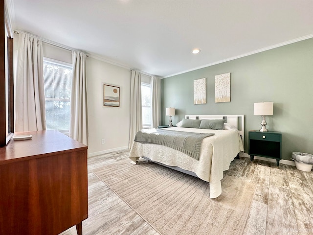 bedroom with ornamental molding and light wood-type flooring