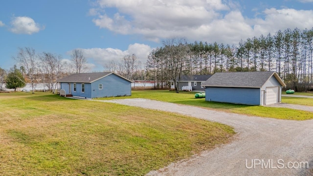 view of yard featuring an outbuilding and a garage